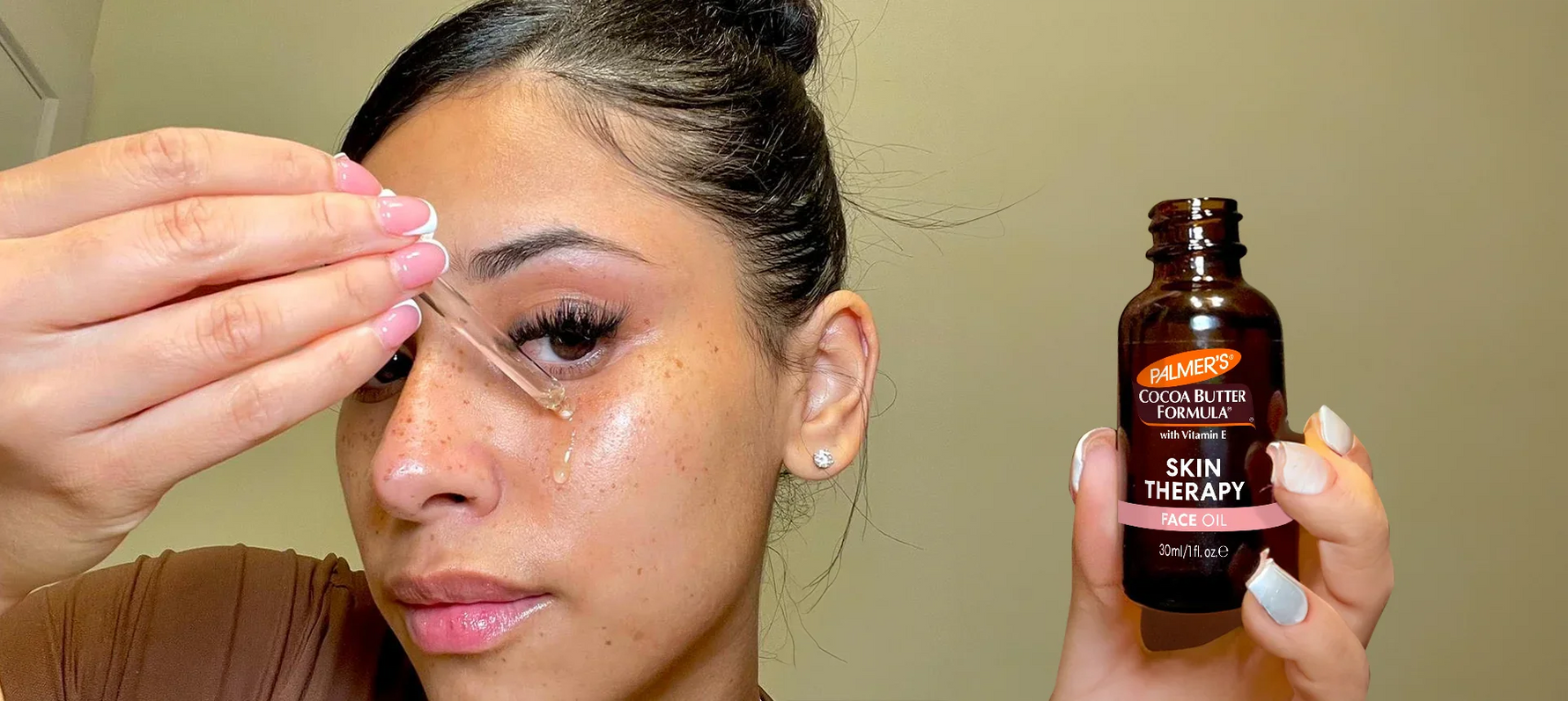 Palmer's Coconut Hydrate Facial Oil and Moisturizer under water splash next to coconut and monoi flower