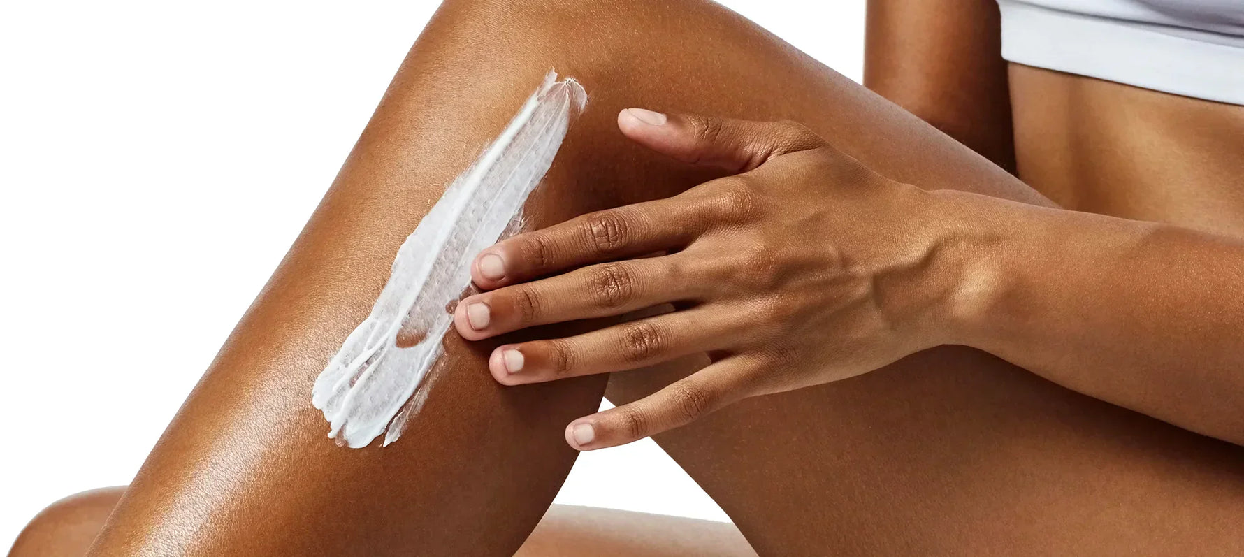 Close up of woman applying lotion to her leg
